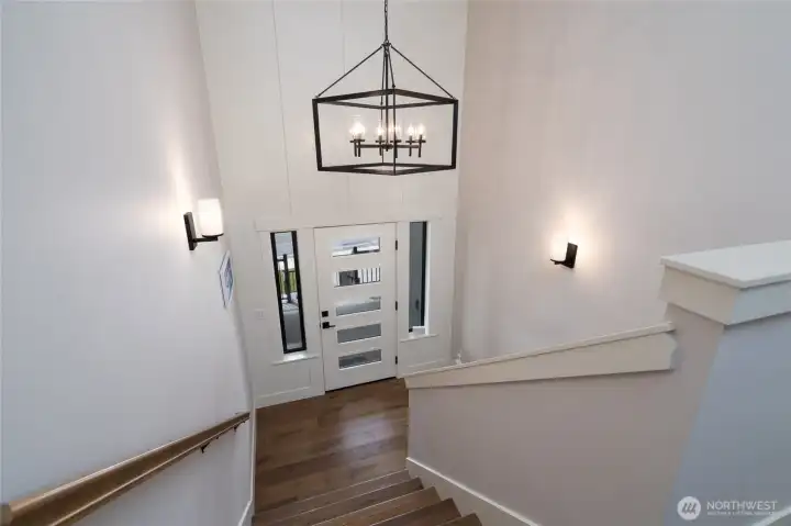 Grand entryway with soaring ceilings and elegant modern lighting. Grand entryway with soaring ceilings and elegant modern lighting.