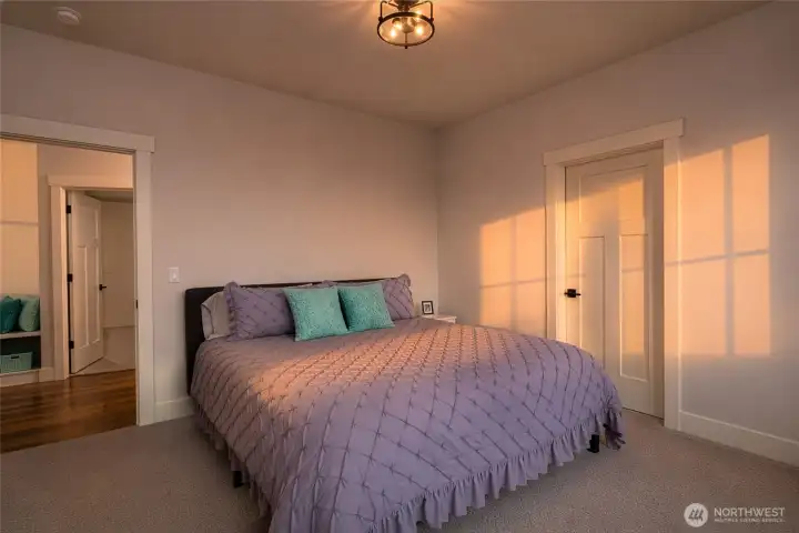 Cozy bedroom bathed in warm sunset light and inviting comfort. Cozy bedroom bathed in warm sunset light and inviting comfort.