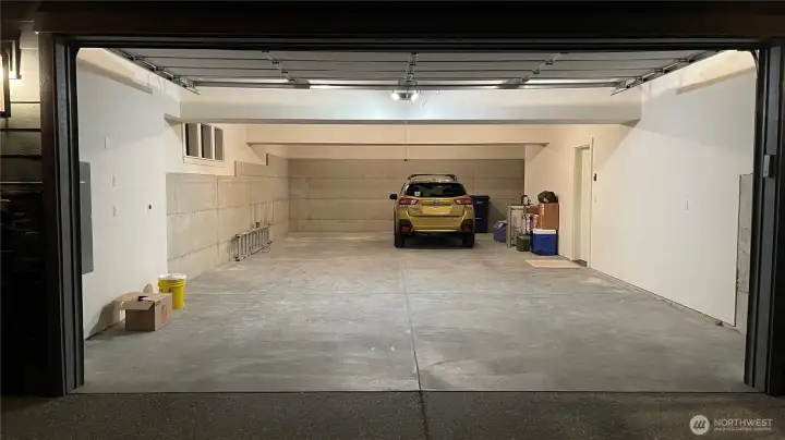 Oversized garage with ample space for parking, storage, and hobbies. Oversized garage with ample space for parking, storage, and hobbies.