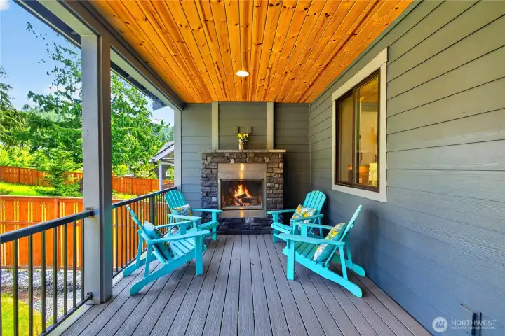 Cozy covered patio with fireplace for year-round outdoor living. Cozy covered patio with fireplace for year-round outdoor living.