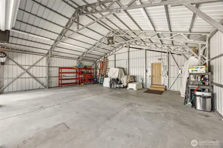 Complete with substantial concrete slab, RV-height clearance, exceptional lighting, and three garage bays designed for larger projects, storage, and more.