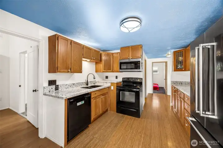 Updated kitchen features Pental Quartz countertops, newer appliances, bamboo flooring, and all appliances included
