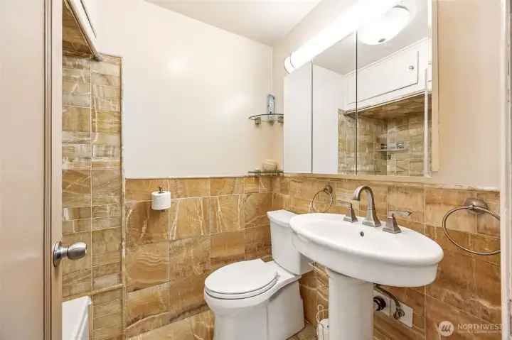 Full bathroom on main floor with striking honey-onyx tile.