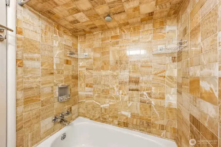 Full bathroom on main floor with striking honey-onyx tile.