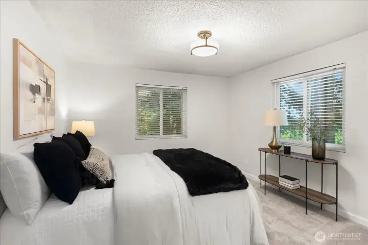 Primary with ensuite offering tree lined views and double closets.