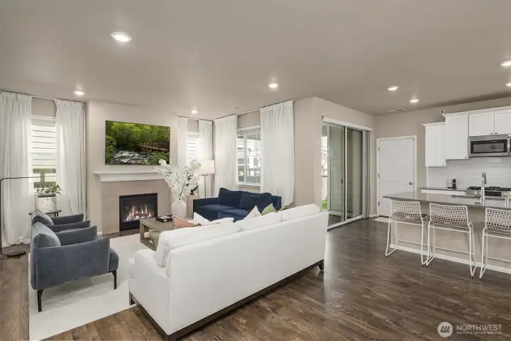 Living room with inviting gas fireplace and direct access to the covered back patio overlooking the fully fenced backyard