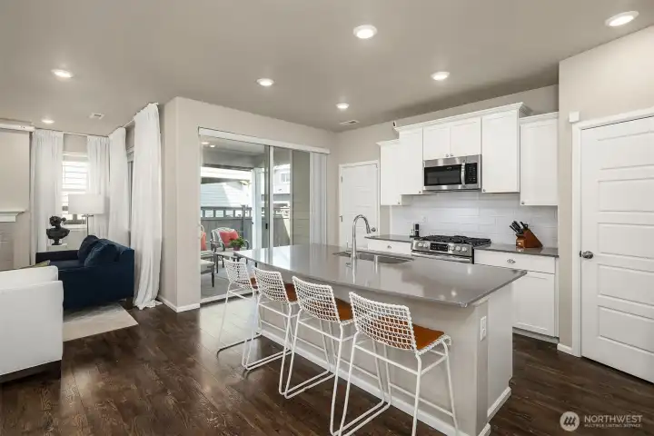 Living room with inviting gas fireplace and direct access to the covered back patio overlooking the fully fenced backyard