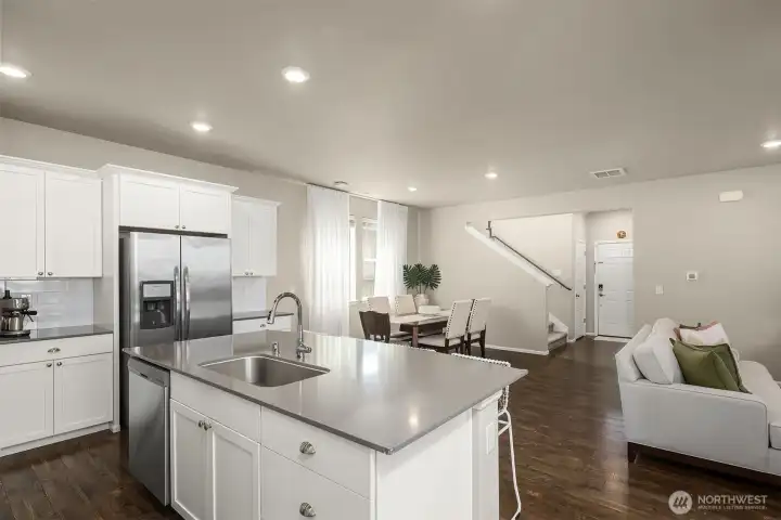 Gorgeous chef's kitchen with quartz counters, pantry, lots of work space and hug island with eating bar