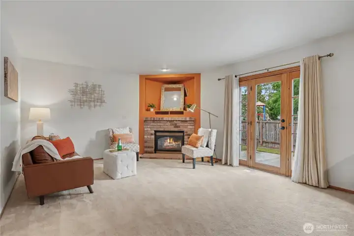 Family room with gas fireplace opens to patio area.