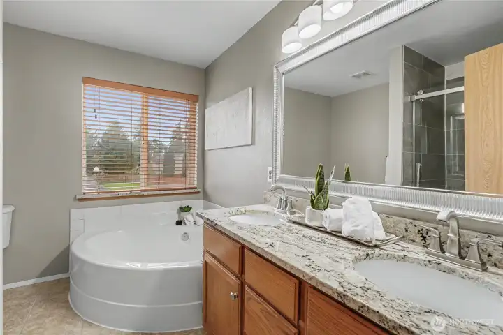 Primary offers garden tub and separate shower.