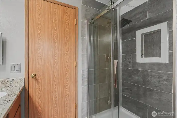 Over-sized tiled shower with convenient niche.