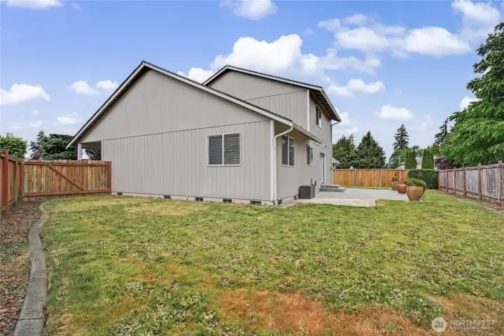 Large side yard and concrete border. Back yard is wired for a hot tub.
