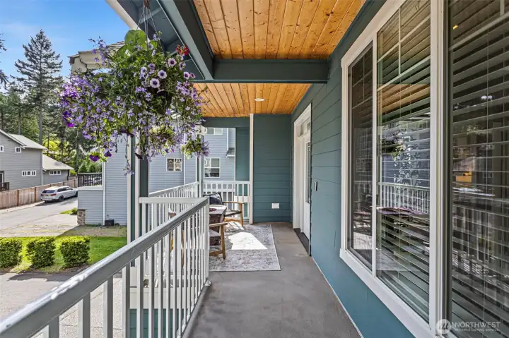 Covered front porch with seating area.