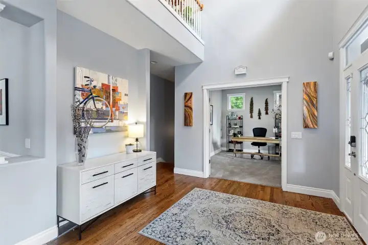 Generous entry space with french doors into an office on the main floor and oak hardwood floors. Balcony above open to oversized hallway on second level.