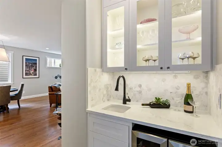 Classy wet bar connects kitchen to formal dining room.