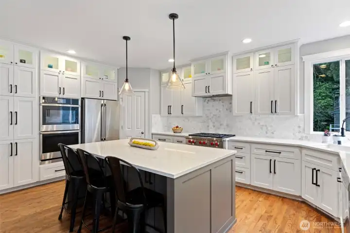 Quartz counters, marble octagon tile backsplash, power strip, Pottery Barn pendant lights.