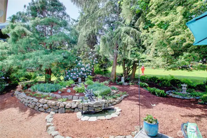 Landscaped water feature with small stream and pond. Landscaped water feature with small stream and pond.
