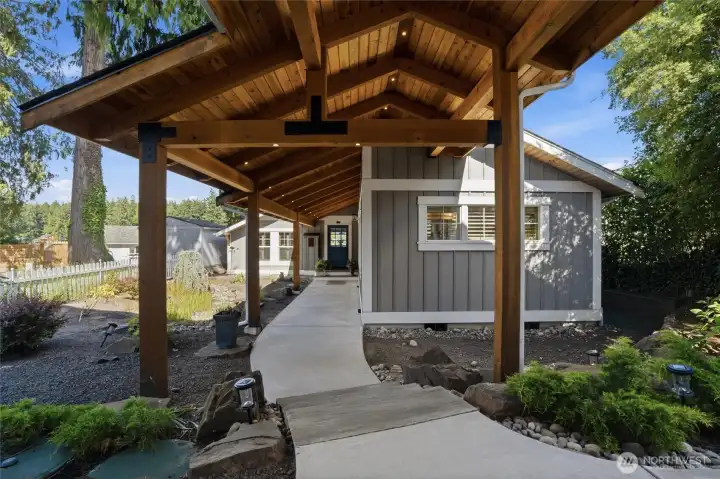 Stunning timber frame breezeway connecting the double garages to the main residence, providing seamless, weather-protected access for groceries and daily arrivals. Stunning timber frame breezeway connecting the double garages to the main residence, providing seamless, weather-protected access for groceries and daily arrivals.