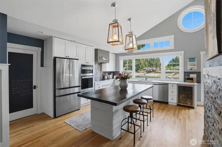 This delightful kitchen is a chef’s dream, featuring exquisite oak hardwood flooring that flows seamlessly throughout the space. The heart of the home is anchored by a large kitchen island, perfect for meal preparation or casual dining. Culinary enthusiasts will appreciate the modern stainless steel appliances and durable, high-quality countertops designed for both style and longevity. Every detail in this space has been thoughtfully considered to offer a blend of elegance and functionality that truly elevates the home. This delightful kitchen is a chef’s dream, featuring exquisite oak hardwood flooring that flows seamlessly throughout the space. The heart of the home is anchored by a large kitchen island, perfect for meal preparation or casual dining. Culinary enthusiasts will appreciate the modern stainless steel appliances and durable, high-quality countertops designed for both style and longevity. Every detail in this space has been thoughtfully considered to offer a blend of elegance and functionality that truly elevates the home.
