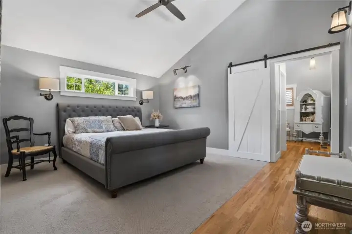 Primary bedroom featuring brand new carpeting, soaring vaulted ceilings, a spacious walk-in closet, and an inviting en-suite bathroom complete with a modern walk-in shower. Primary bedroom featuring brand new carpeting, soaring vaulted ceilings, a spacious walk-in closet, and an inviting en-suite bathroom complete with a modern walk-in shower.