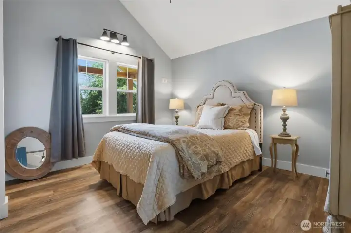 Spacious bedroom featuring durable vinyl plank flooring and impressive vaulted ceilings. This inviting retreat offers beautiful views of Horsehead Bay and the added comfort of a private air conditioning unit. Spacious bedroom featuring durable vinyl plank flooring and impressive vaulted ceilings. This inviting retreat offers beautiful views of Horsehead Bay and the added comfort of a private air conditioning unit.
