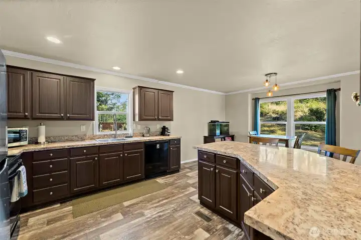 Open kitchen with lots of cabinets and counterspace.