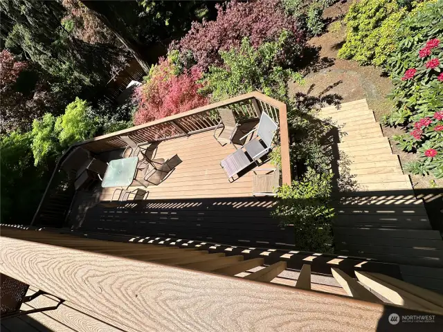 Extra wide steps down the terraced back yard make it convenient and safe to access this space. This yard is filled with the most beautiful plants and flowers. Be sure to visit now to see everything in full bloom.