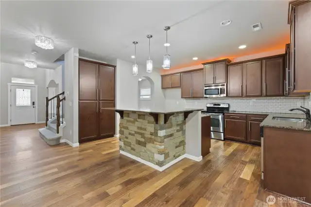 Large kitchen with granite countertops.