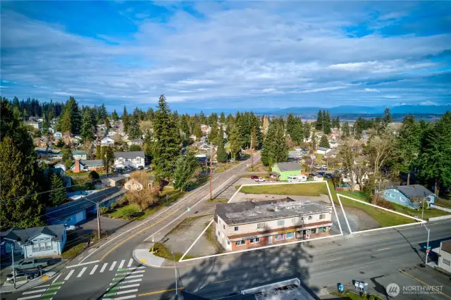 Dynamic mixed-use asset in Everett’s revitalizing urban core. Interurban Crossing spans a 26,572 SF corner lot with alley access, 20+ parking spaces, and a 7,629 SF structure leased to stable local tenants—3 storefronts, 3 apartments, and 3 flex spaces. Current gross rent over $64K; pro forma $144K+ with light upgrades. Just 26.3% lot coverage—NB zoning + Opportunity Zone offer phased development potential. Steps from the Interurban Trail, future light rail, and new stadium district. A walkable, well-connected location with built-in income and big upside.