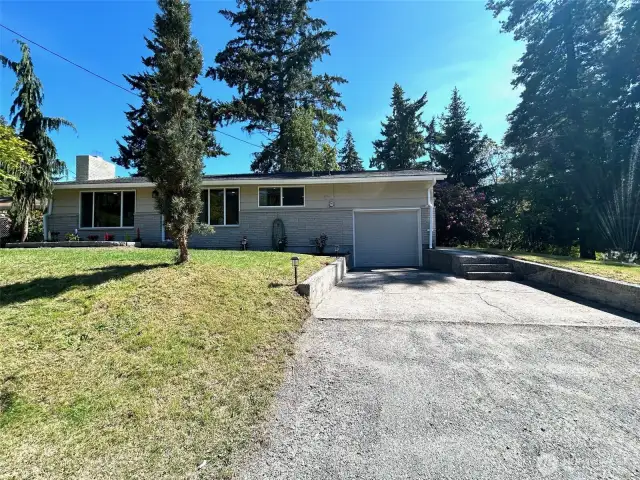 front view of home, including driveway into garage
