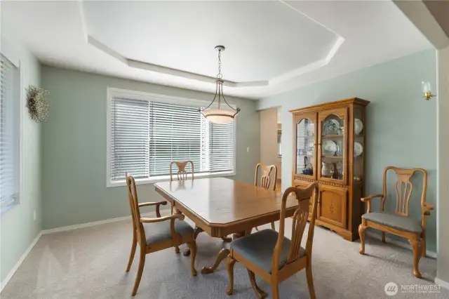 The formal dining room is conveniently situated just off the kitchen, providing a seamless flow that makes entertaining a breeze.