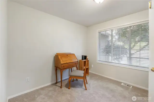The den or home office overlooks the front yard and is filled with natural light—offering a bright and inspiring space to work or relax.