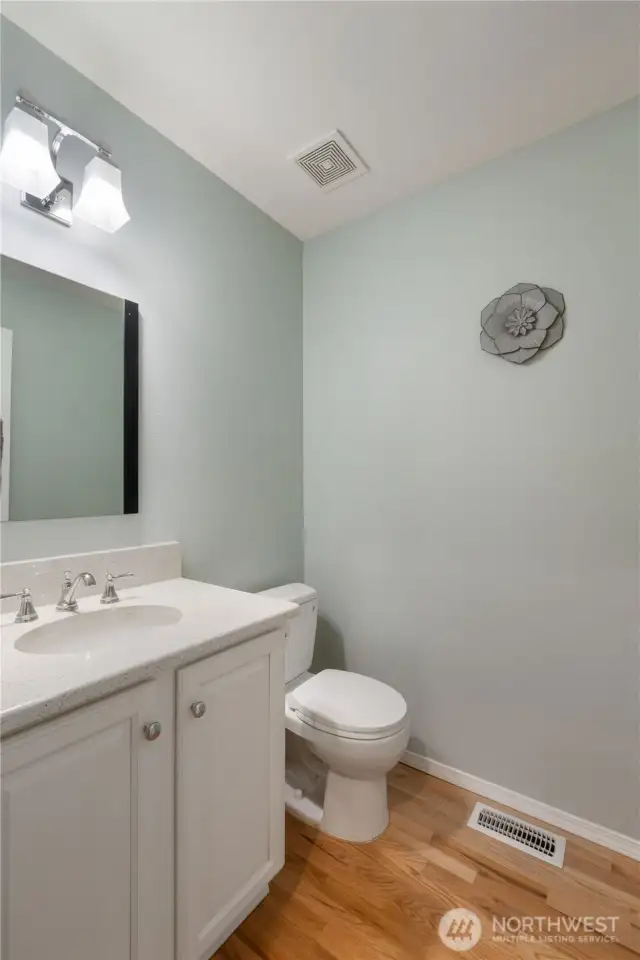 A conveniently located powder room is situated on the main level for guests and everyday use.
