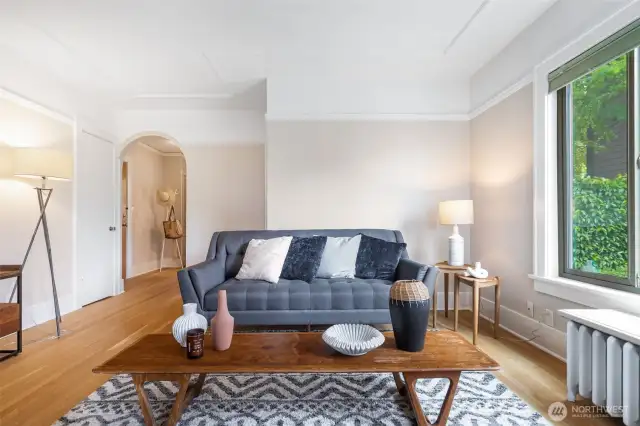 Great wall space for art, another big closet, an arched passageway to the back foyer, kitchen, bedroom and bath.