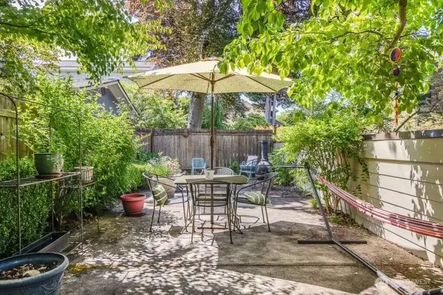 The private patio tucked up a few stairs, next to the southern carport, is a perfect spot to unwind, explore your green thumb, BBQ, or entertain friends.