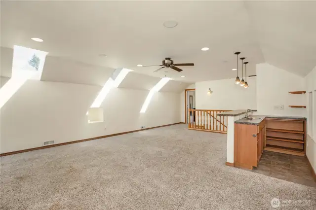 Upstairs Living Space W/ A Bar. Natural Lighting From The Skylights