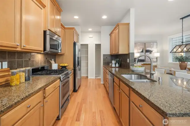 Kitchen features SS appliances and stone countertops.  Ample storage and pantry space.