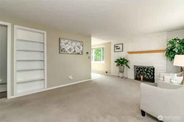 Living room is light and bright and features a fireplace and insulated windows