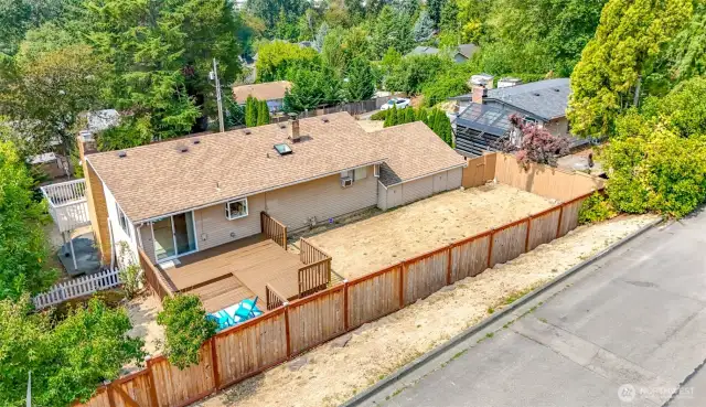 Host a BBQ for friends on this large deck and fenced yard.  Access to east side of property is available from this street, 95th Pl.