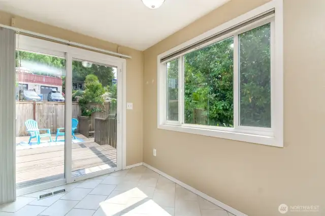 Dining area with access to the large deck and fenced backyard, great for entertaining!