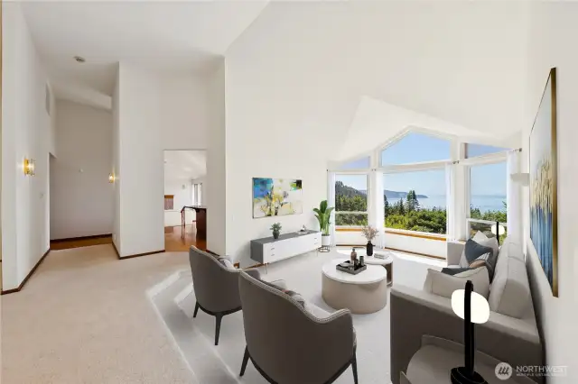 Tall vaulted ceilings create an open main level.  Virtually staged.
