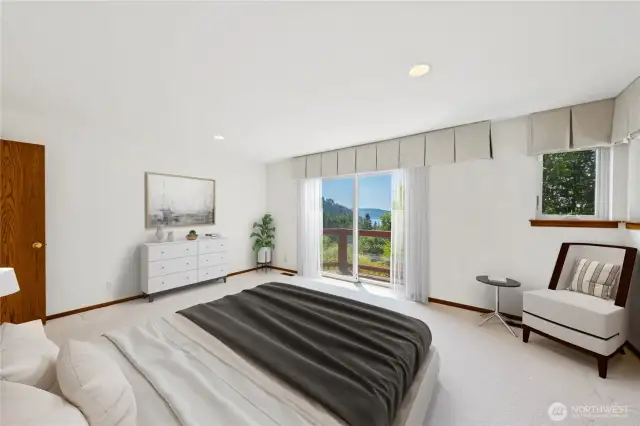 Primary bedroom on the main level with deck access and large ensuite.  Virtually staged.
