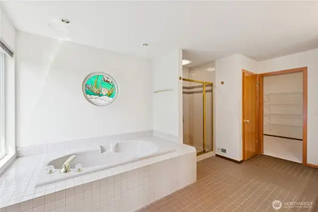 Custom stained glass portal and natural light in primary ensuite.