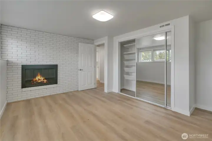Downstairs bedroom with a fireplace