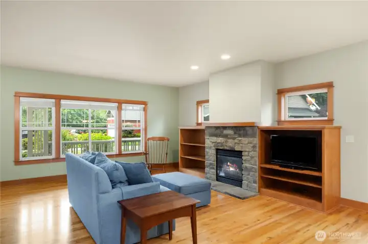 Built in shelves and windows set off the fireplace.