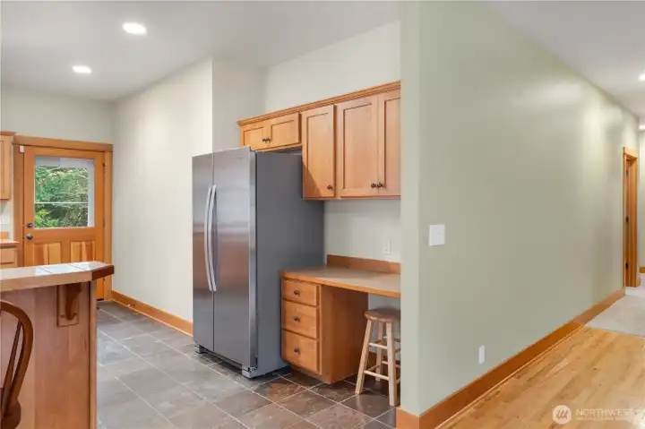 Handy desk area in kitchen. Door to deck in background.