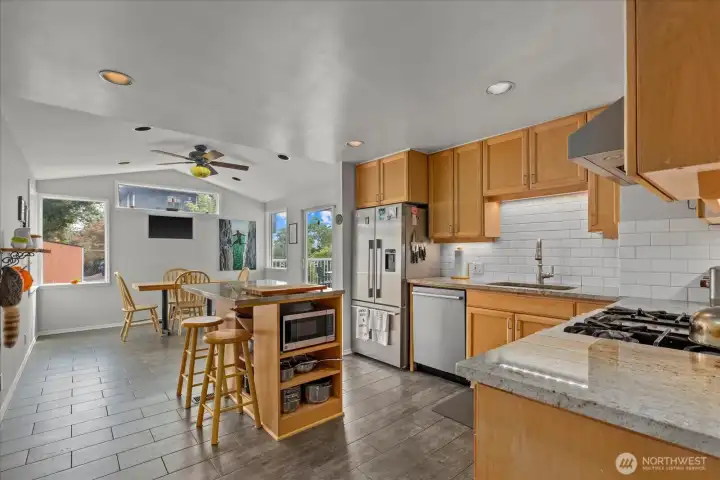 Updated Kitchen with granite counters, island counterspace & seating
