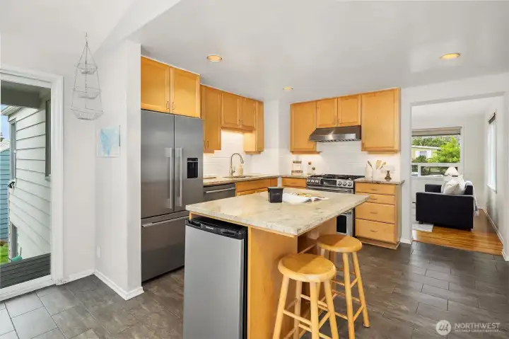 Open concept kitchen and dining with island seating and natural light Open concept kitchen and dining with island seating and natural light