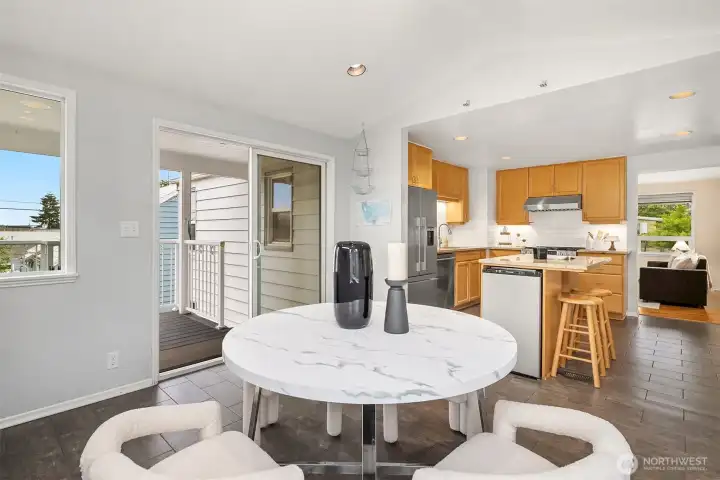 Open concept dining with vaulted ceiling and natural light Open concept dining with vaulted ceiling and natural light