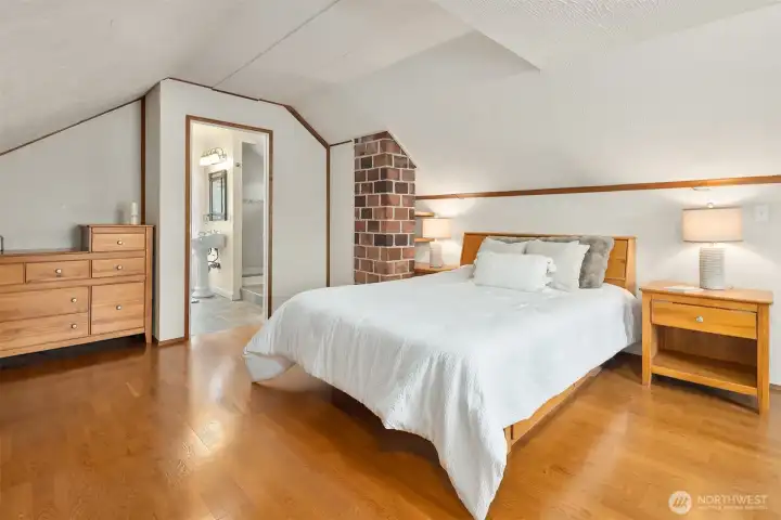 Primary bedroom with en suite bath, walk-in closet, and hardwood floors Primary bedroom with en suite bath, walk-in closet, and hardwood floors